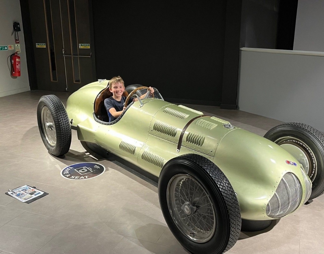 Y5 pupil in 1950s racing car at Silverstone museum.