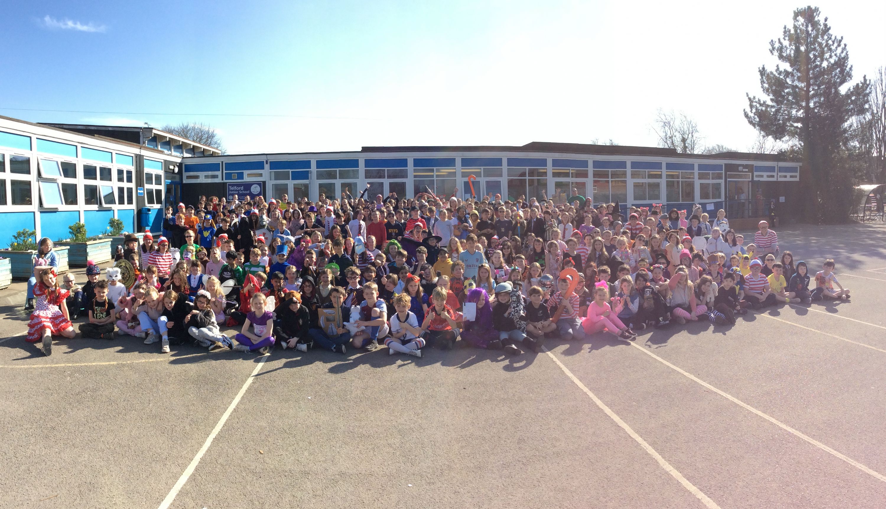 Picture of the whole school on the playground, dressed as book characters.