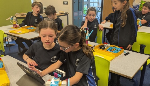 Picture showing pupils working with the robotics kits.